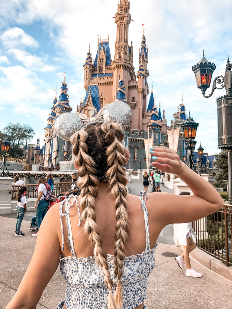 two braid hairstyle in front of the Disenyworld Castle